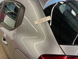 a silver car with a sticker on the side of it