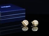 a pair of cufflinks that are sitting on a table