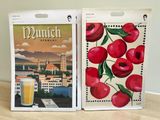 a picture of a box with a picture of a city and a glass of beer