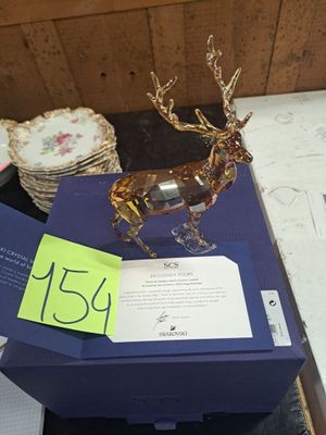 a blue box with a gold deer figurine on top of it