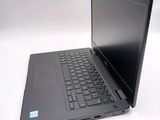 a black laptop with a black keyboard on a white surface