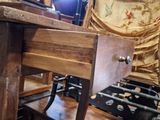 a wooden table with a sewing machine on top of it