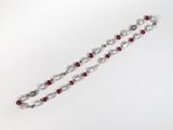 a close up of a red and white beaded bracelet