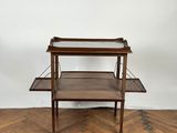 a wooden table with two shelves on top of it