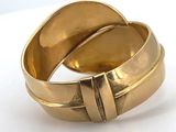 an image of a close up of a gold ring on a white surface