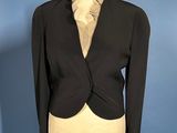 a picture of a black jacket and tie on a mannequin
