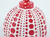 a red and white polka dot pumpkin on a white background