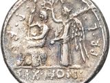 an old silver coin with an image of a man and a woman on it