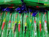 a box full of green and red fishing lures
