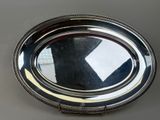a silver plate with a mirror in the middle of it