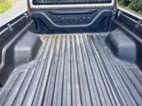a truck bed with a cage in the back of it
