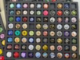 a lot of different types of bottle caps in a black tray