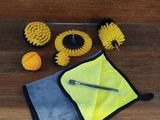 a close up of a yellow and black cleaning kit on a wooden floor