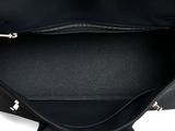 the large black tote bag is open and ready to be carried