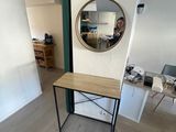 a small table with a mirror on it in a room