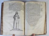 someone is holding a book with a drawing of a monk on it