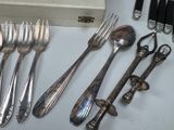 a lot of silver spoons and forks on the table