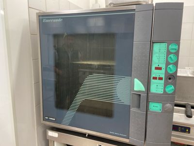 an oven that is sitting in the kitchen with the door open
