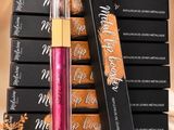 a stack of lipsticks next to a stack of boxes