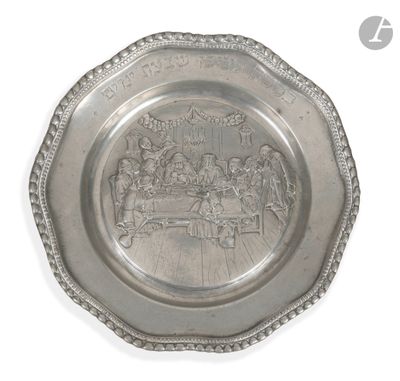 an image of a silver plate with a picture of a group of people on it