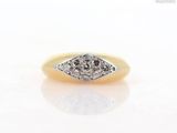 a close up of a diamond ring on a white surface