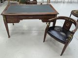 a desk and chair in a room with a lot of chairs