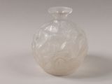 a white vase with a pattern on it on a white surface