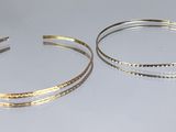two bang bracelets on a white background