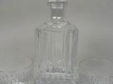 two glasses and a decanter on a table