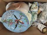 a blue plate with a bird on it sitting in a box