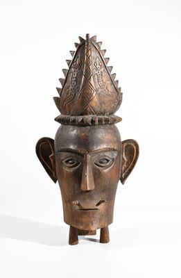 a close up of a wooden head with a crown on it