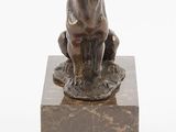 an image of a statue of a bull sitting on top of a marble block