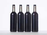 three bottles of wine are lined up on a table