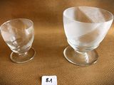 two empty wine glasses sitting next to each other on a table