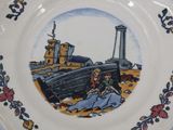 a plate with a picture of a man and a woman sitting on a boat