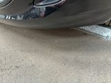 a close up of a car ' s bumper with a denting on it