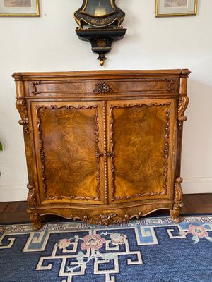 a wooden cabinet with a clock on top of it