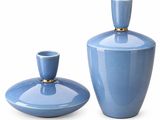 two blue vases sitting next to each other on a white surface