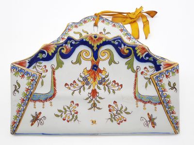 a white purse with blue and yellow designs on it