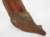 an old wooden object that is sitting on a white surface