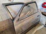 a car that is sitting in the garage with its door open