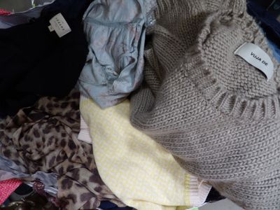 a pile of clothes in a suitcase with a label on it