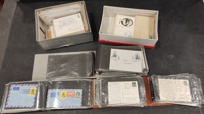 many different types of envelopes in a box on a table