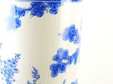 a blue and white vase sitting on a table