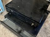 a stack of black boxes on the floor next to a blue box