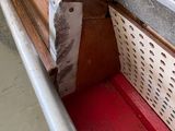 a metal shelf that has a red shelf underneath it