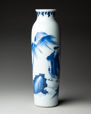 a blue and white vase with a bird on it