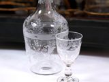 a glass and a decanter on a table