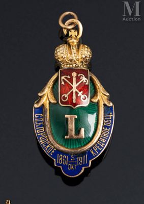 an image of a gold and green enamel badge with a crown on it