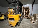 un chariot élévateur dans un entrepôt où se trouvent des palettes de bois